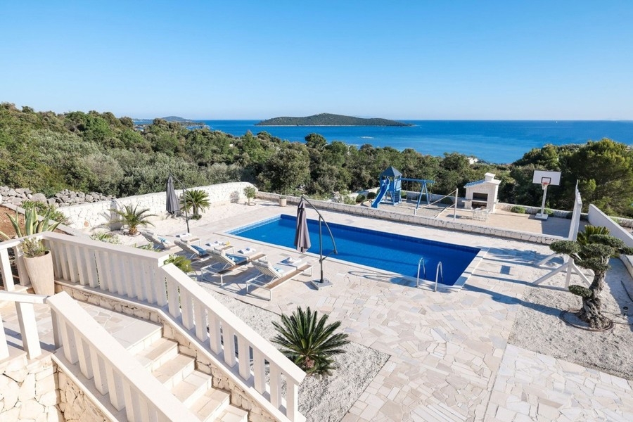 Swimming pool with loungers and sea views