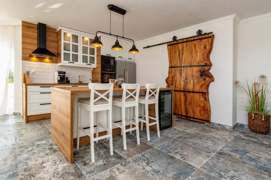 Second kitchen with wooden sliding door in the neighboring villa