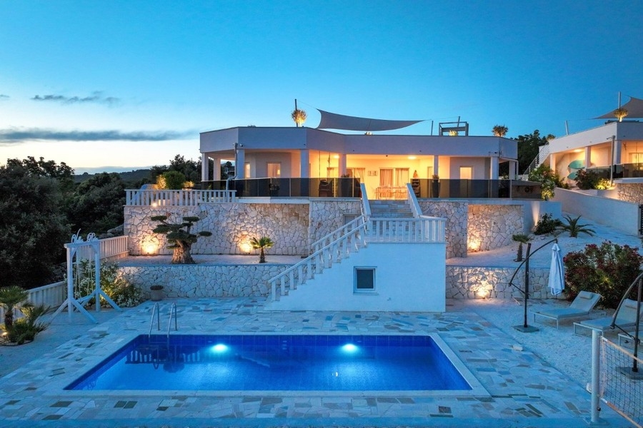Property in the evening with illuminated swimming pool