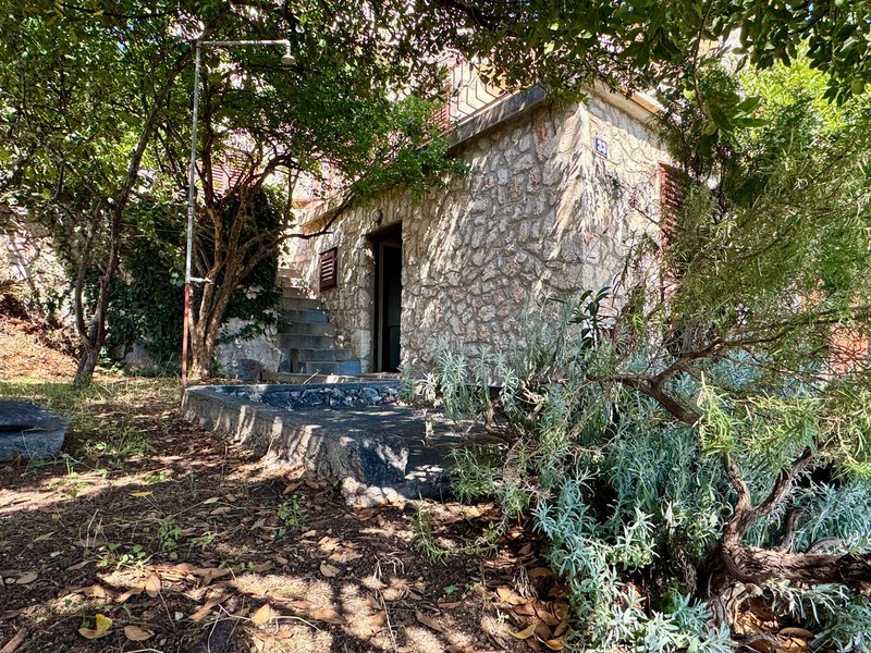 Stone house in the countryside with stairs to the entrance