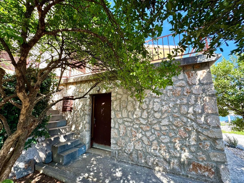 Stone house with entrance door in the garden