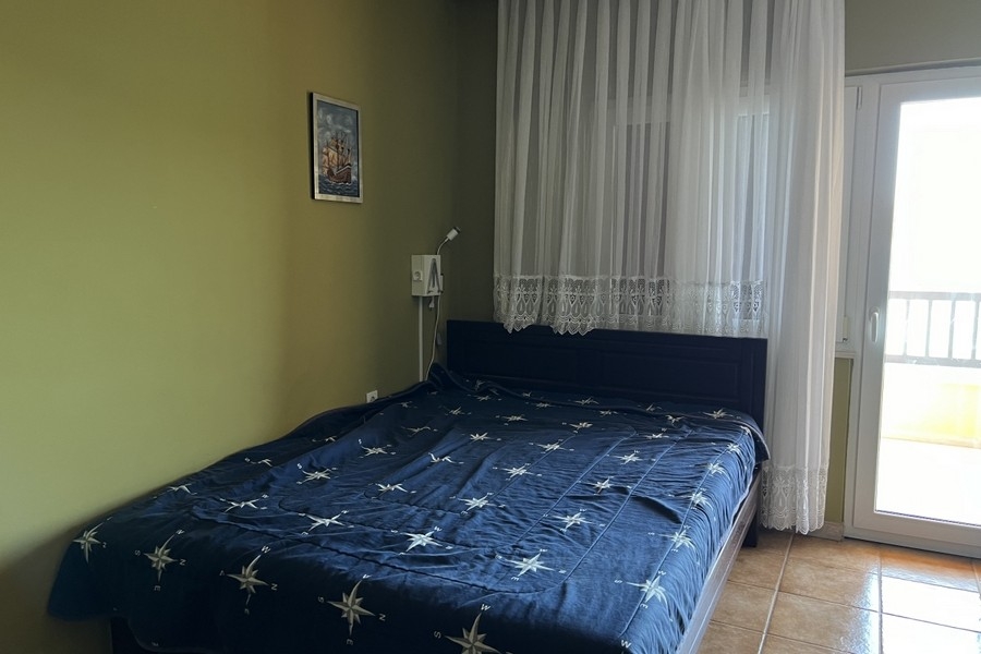 Bedroom with double bed and balcony door
