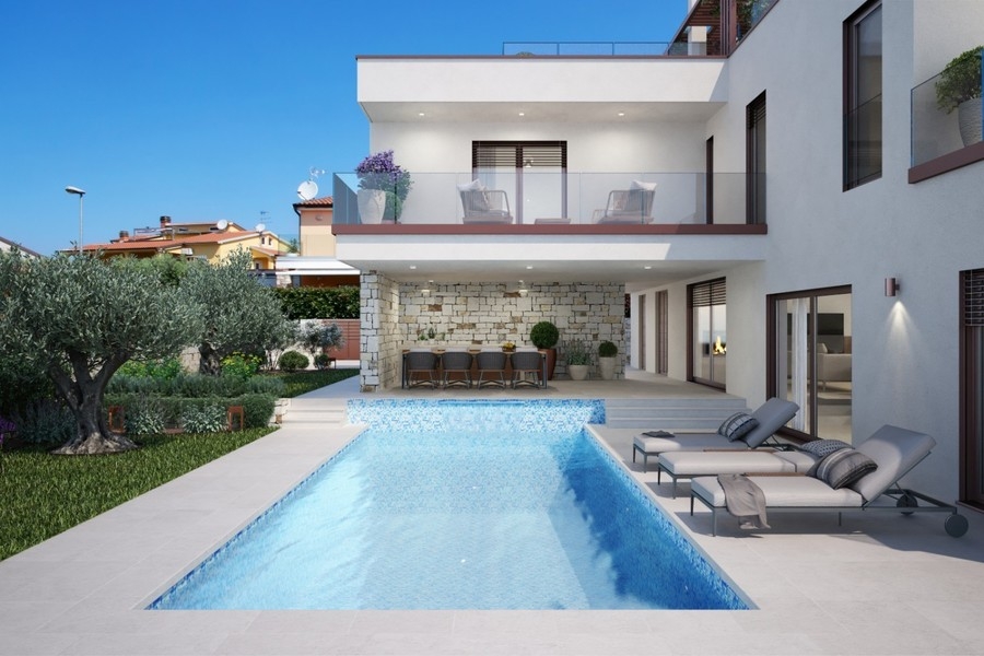 Swimming pool with sunbeds in front of the villa in Novigrad