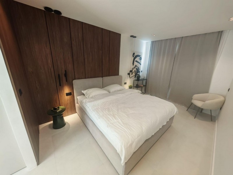 Bedroom with wooden wall and double bed