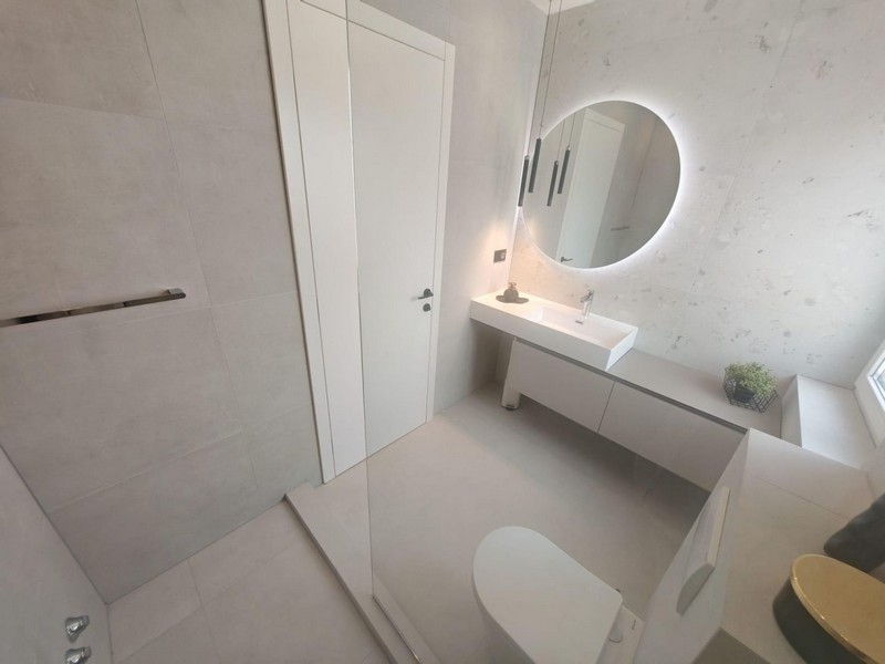 Bathroom with illuminated mirror