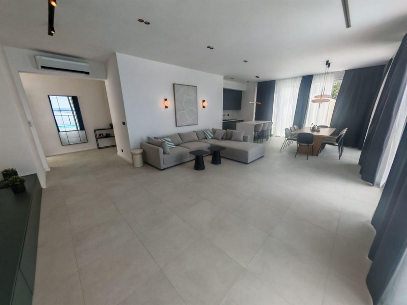 Bright living area with sofa corner and air conditioning