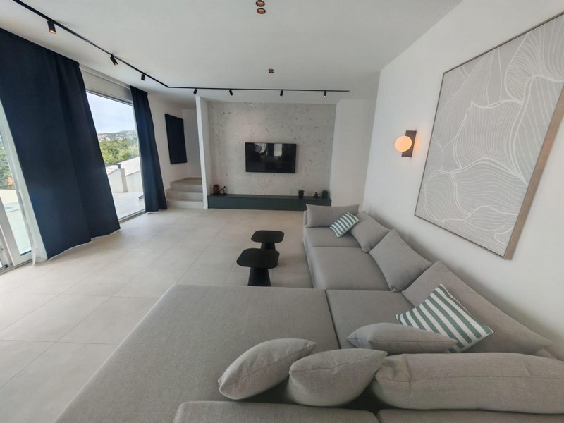 Living room with large sofa corner and television
