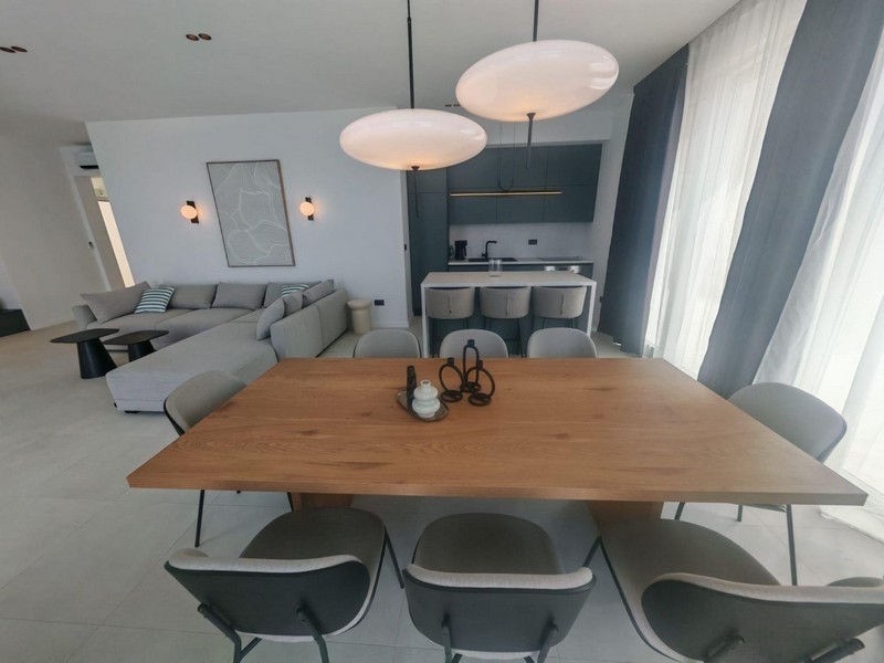 Open living room with dining table and kitchen