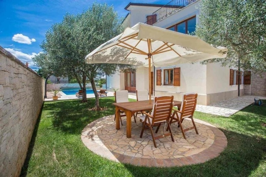 Seating area under olive trees in the garden