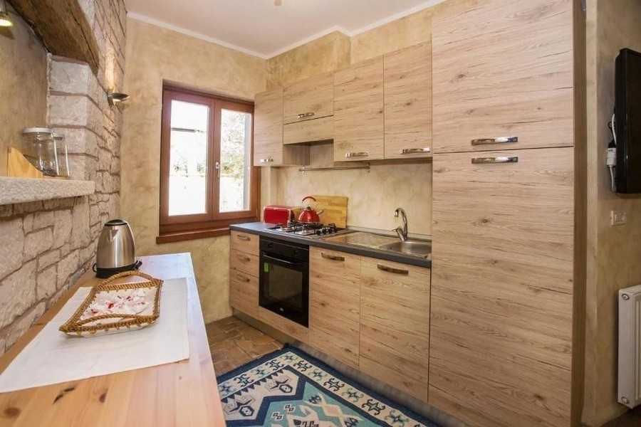 Kitchen with natural stone wall