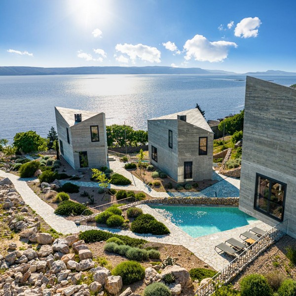 View over the villa with pool to the sea