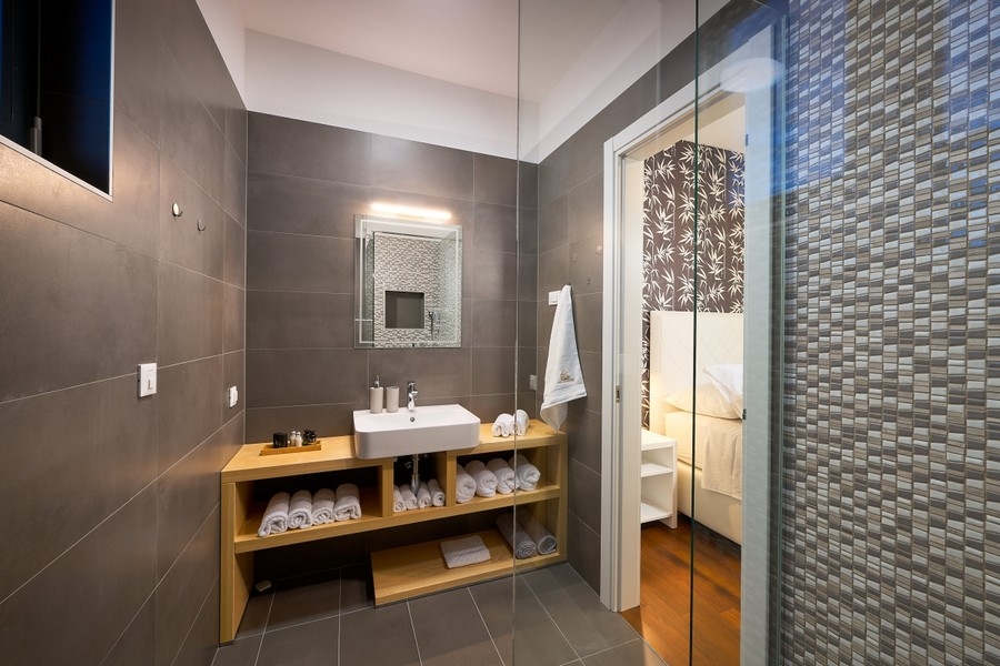 Bathroom with shower and wooden vanity unit