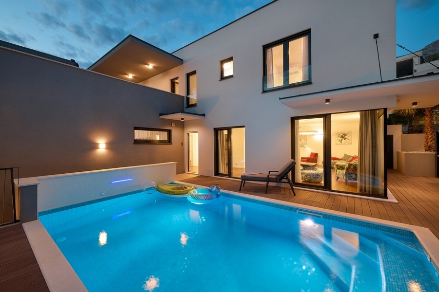Heated swimming pool in front of the villa in the evening