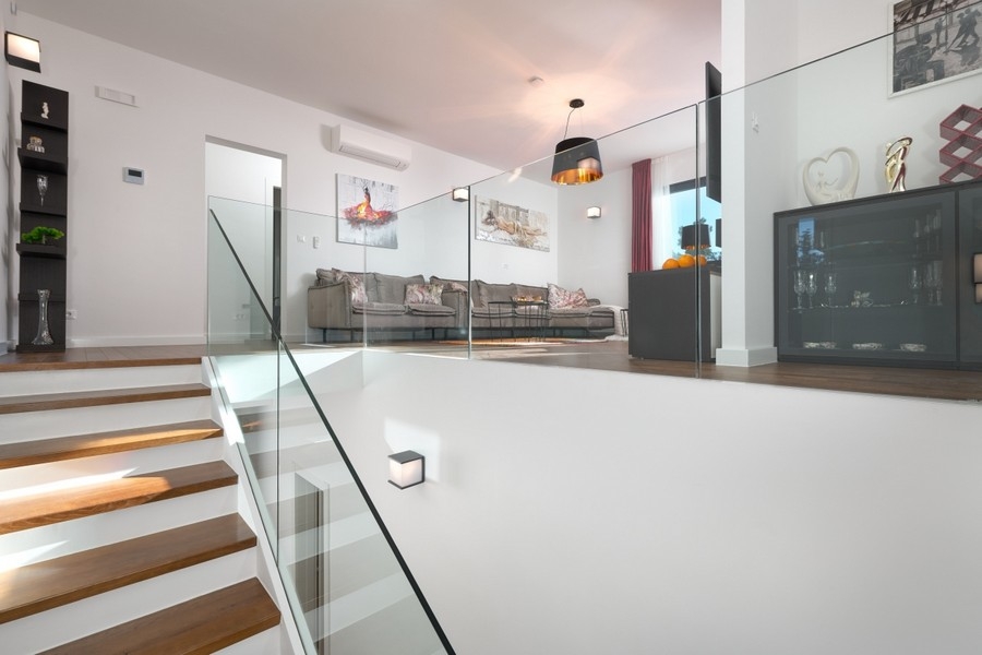 Living area with glass railings and stairs
