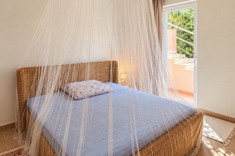 Bedroom with double bed and mosquito net