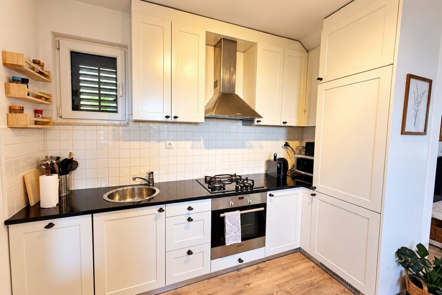 Kitchen with wooden fronts and marble worktop