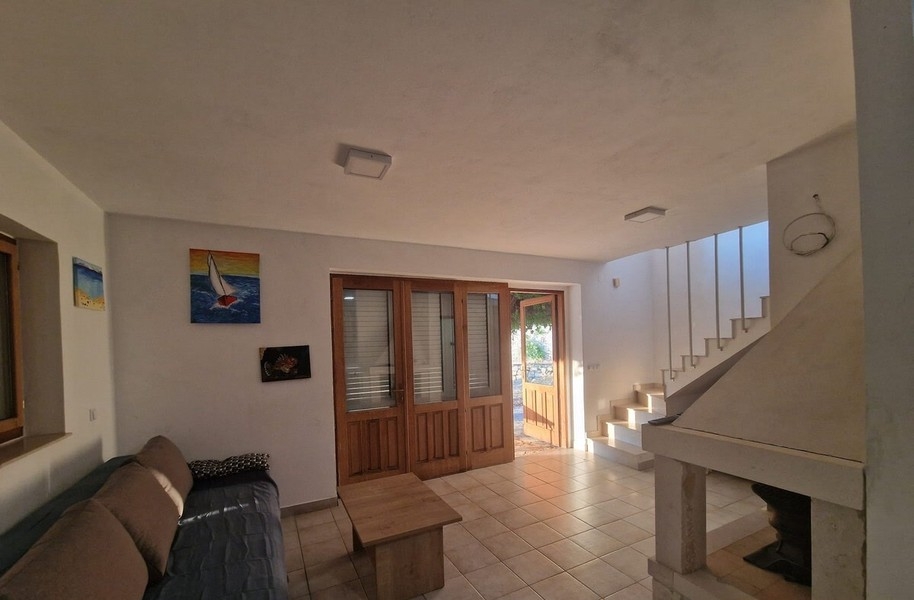 Living area with fireplace and stairs to the upper floor