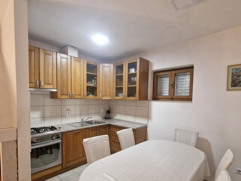 Kitchen with wooden fronts and dining table