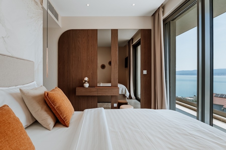 Bedroom with wooden elements and glass front