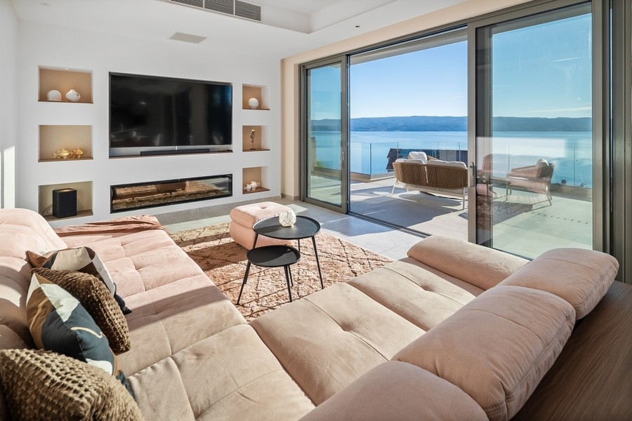 Living room with large glass front and sea view