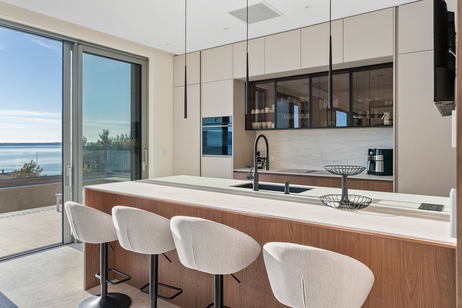 Kitchen island with bar stools and ocean views
