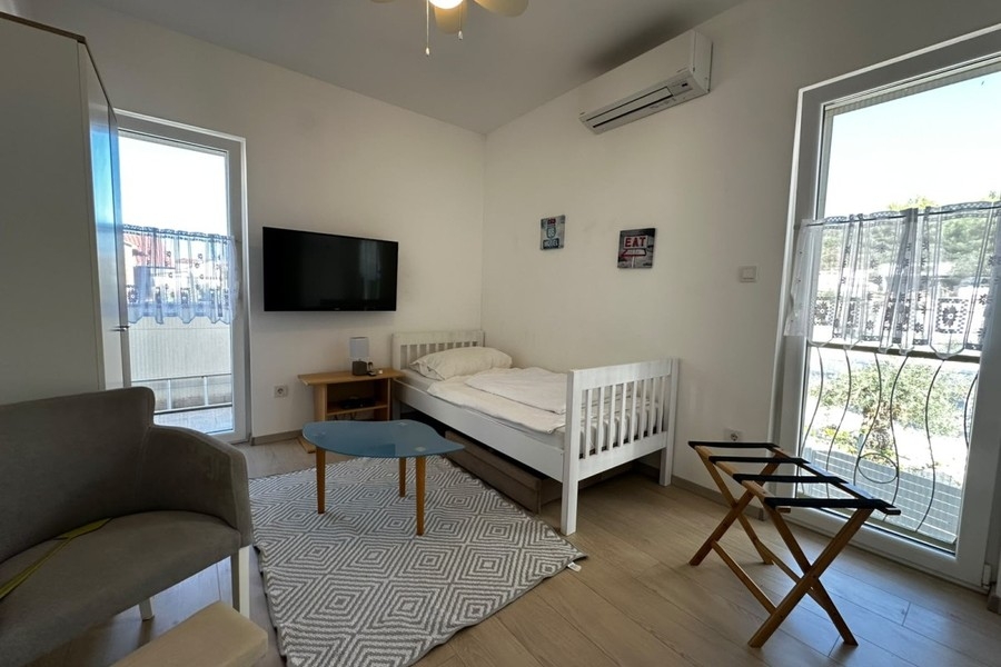 Bedroom with single bed and television