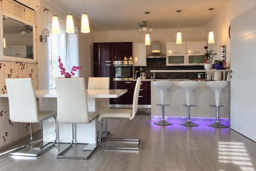Open kitchen with breakfast bar and dining area