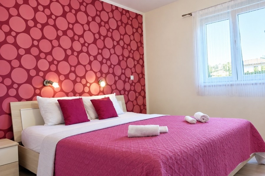 Bedroom with double bed and patterned wall