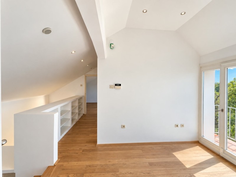 Attic room with built-in shelves