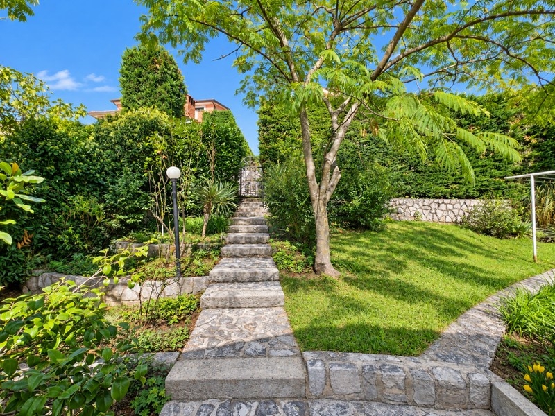 Landscaped garden with stone path and lawn