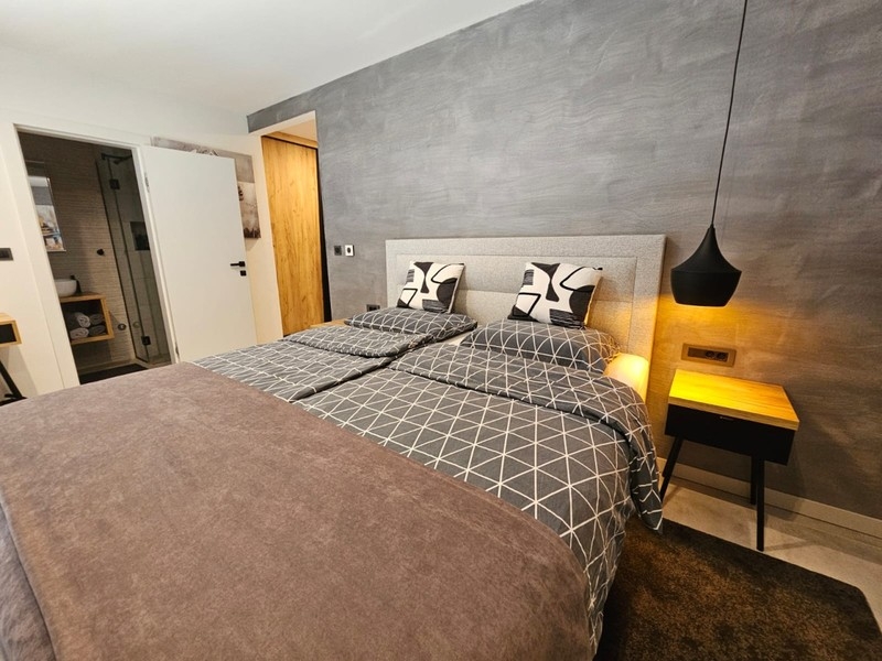 Bedroom with bedside tables and hanging lamp