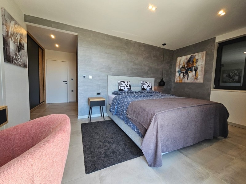 Bedroom with armchair and double bed