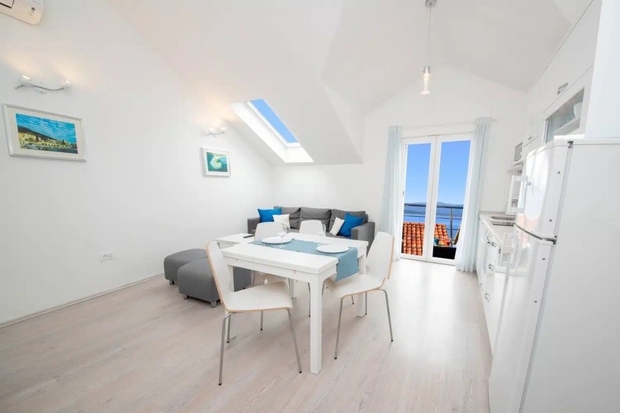 Bright living room with dining table and skylights