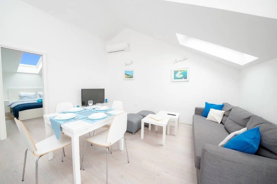 Living room with sofa and set dining table
