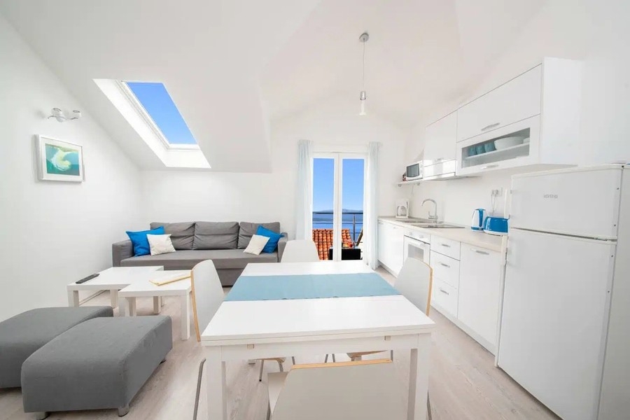 Open living room with kitchen and view of the balcony