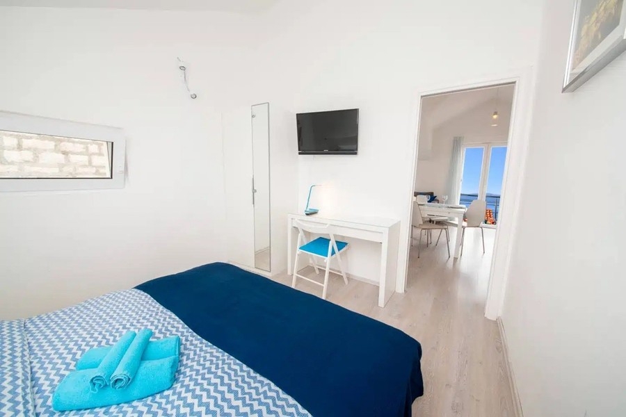 Bedroom with double bed and television