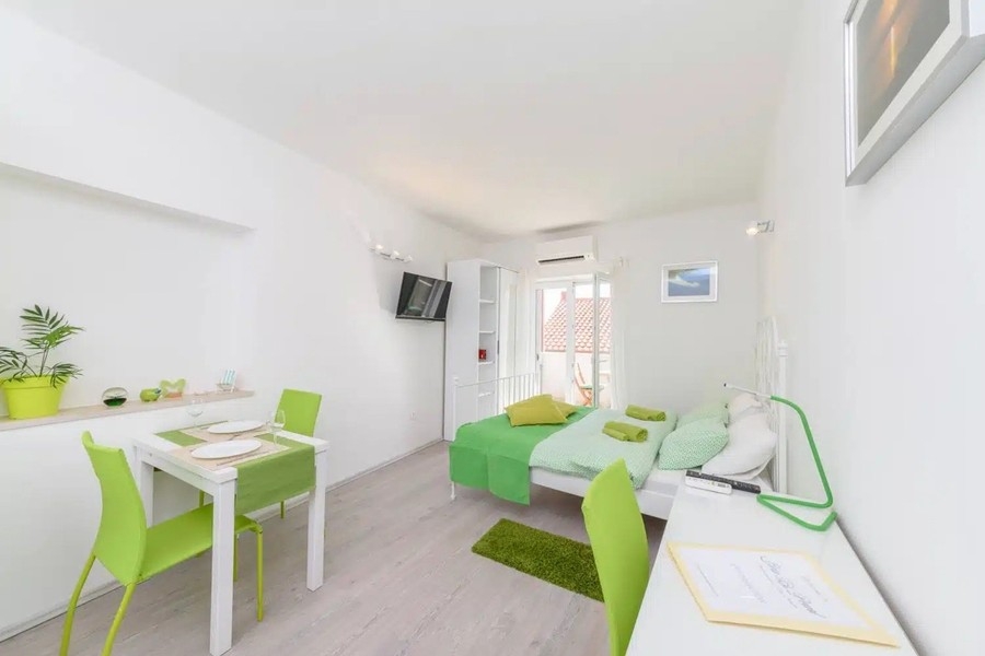 Studio with a kitchenette and green accents