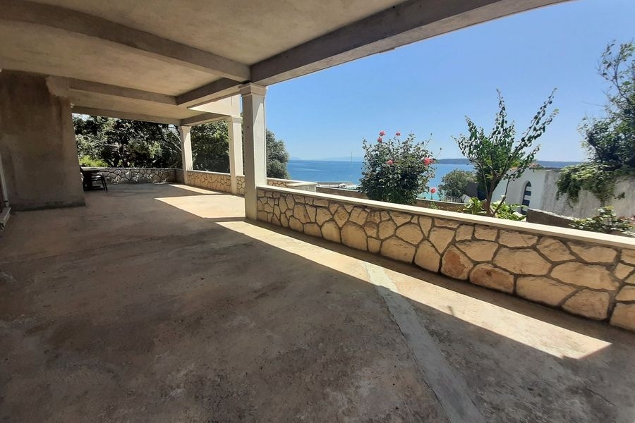 Large terrace with natural stone walls and sea views