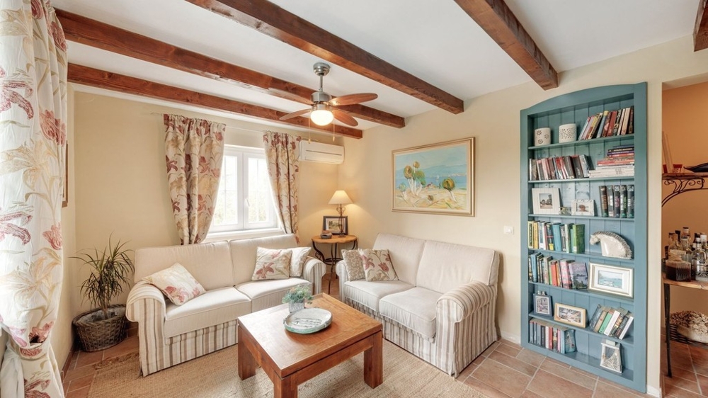 Living room with bookshelf and wooden beams
