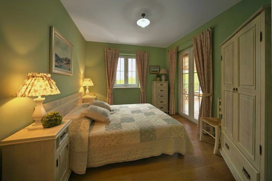 Bedroom with double bed and green walls