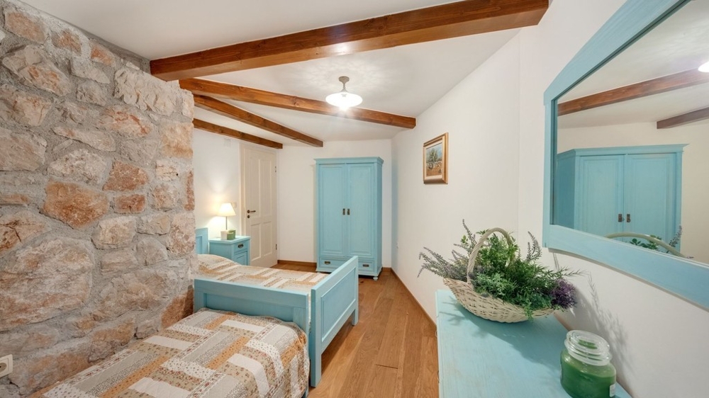 Room with natural stone walls and single bed