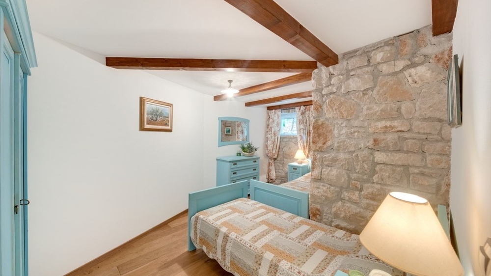 Single room with stone wall and wooden beams