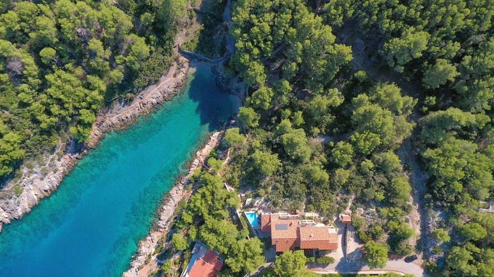 Aerial view of the bay with the house in the pine forest