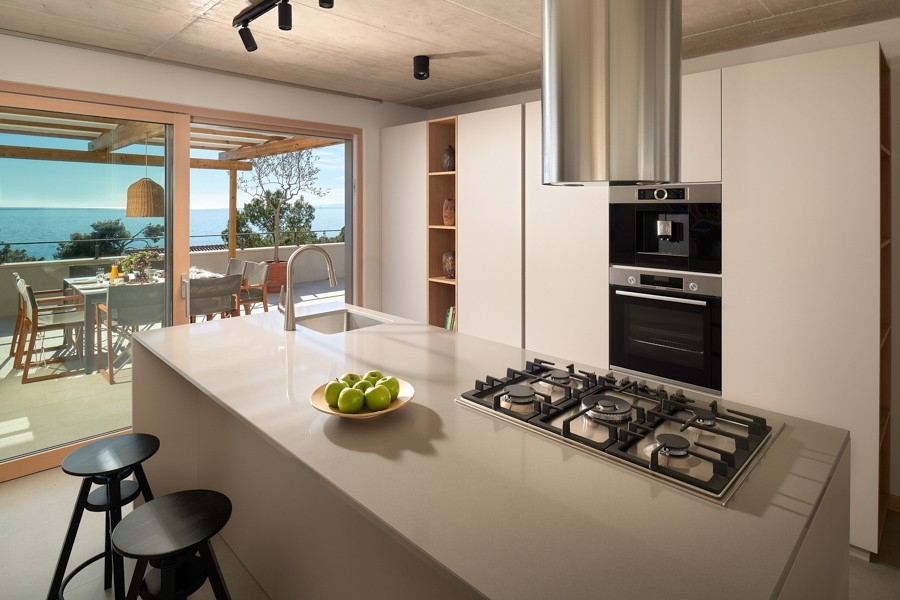 Kitchen island with hob and bar stools