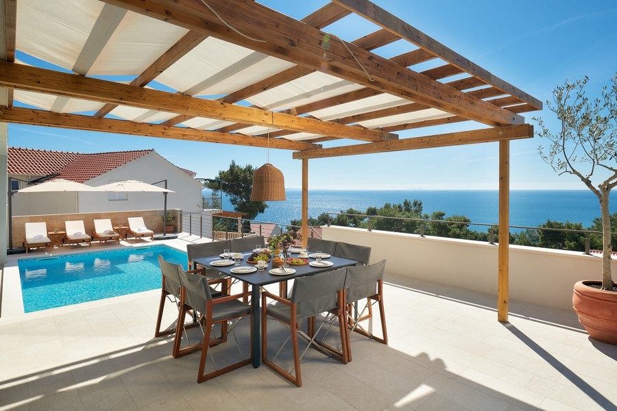 Dining area under the pergola with sea views