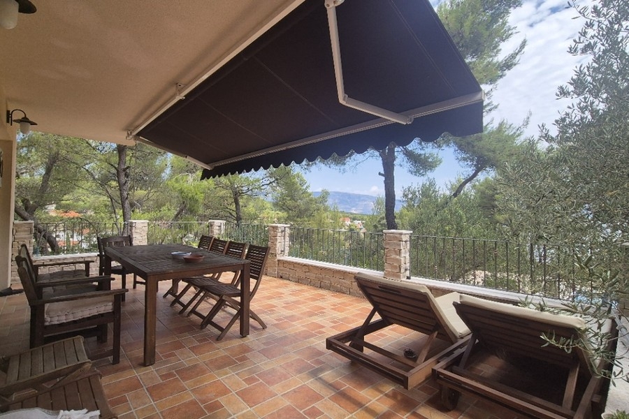 Terrace with awning and sun loungers