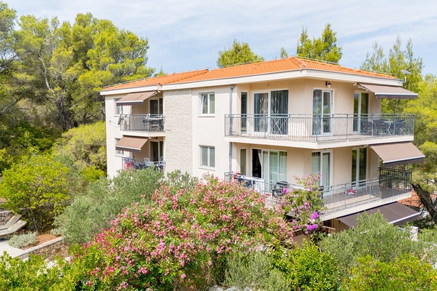 Exterior view of the villa with balconies and garden