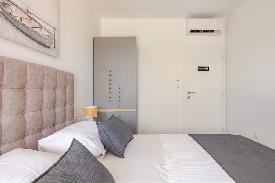 Bedroom with built-in wardrobe and air conditioning