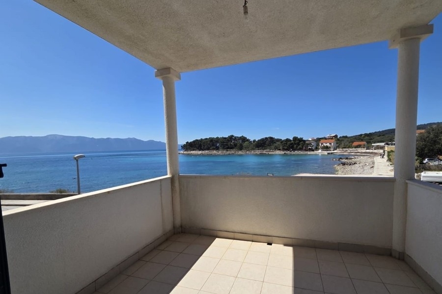 Covered terrace overlooking the beach and sea