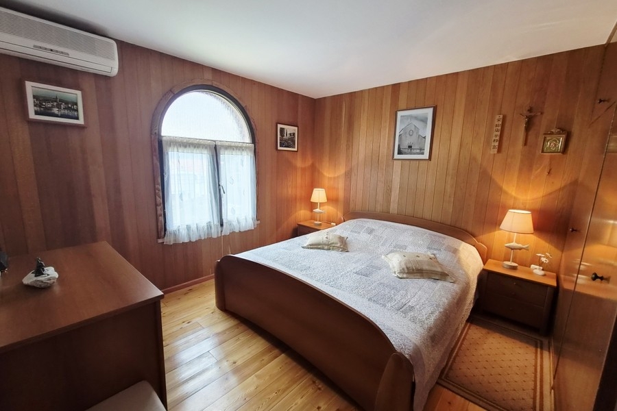 Bedroom with wooden paneling